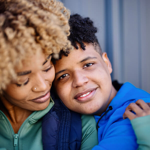 mother and son embracing and smiling